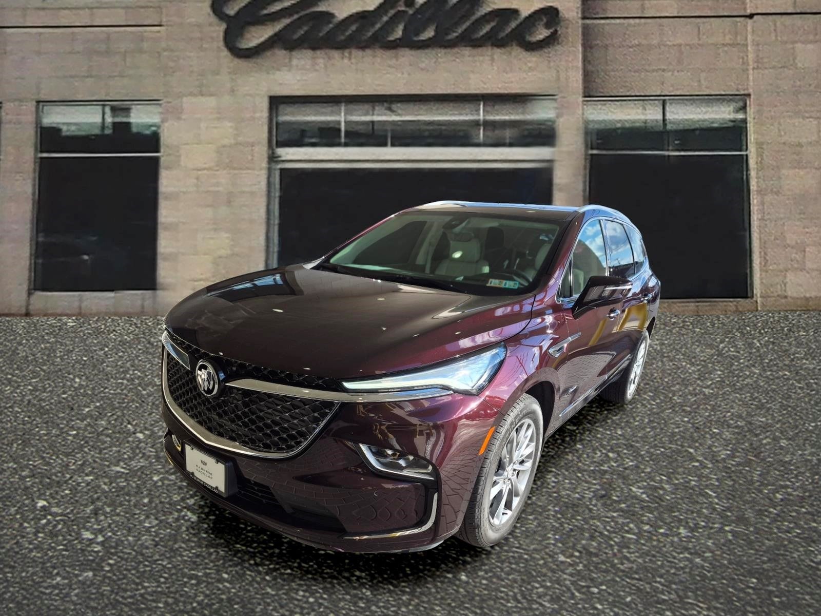 2024 Buick Enclave Avenir in Rich Garnet Metallic — front three-quarter view